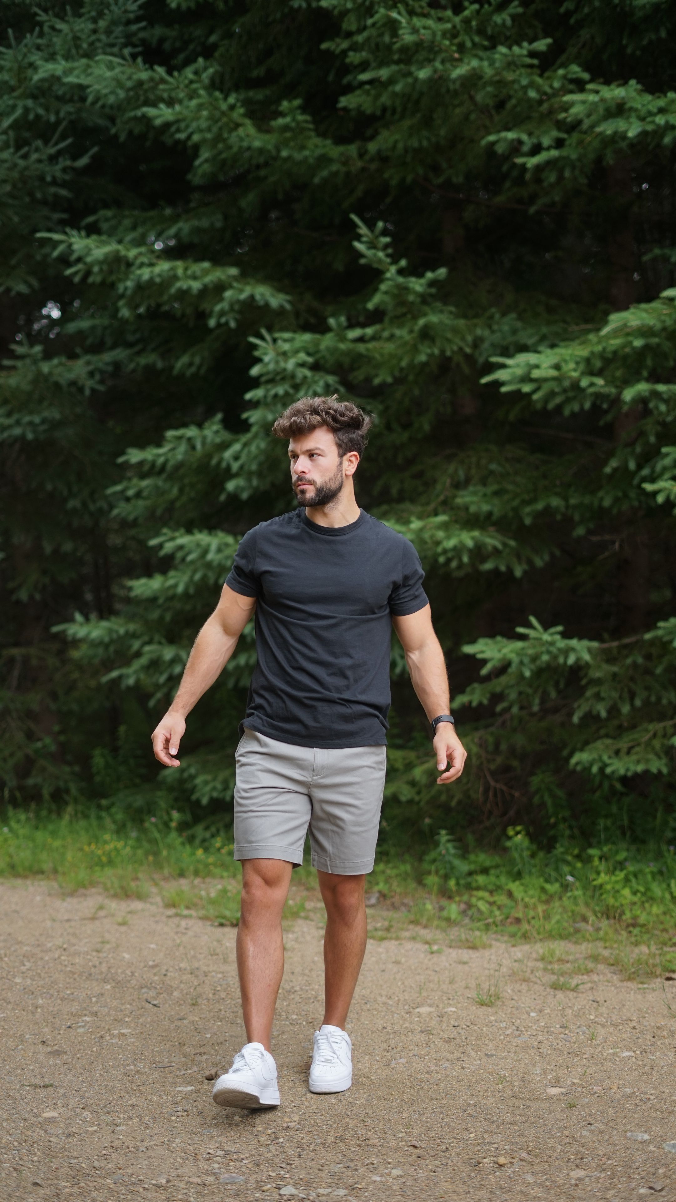Man in a Tech Tee walking on a trail