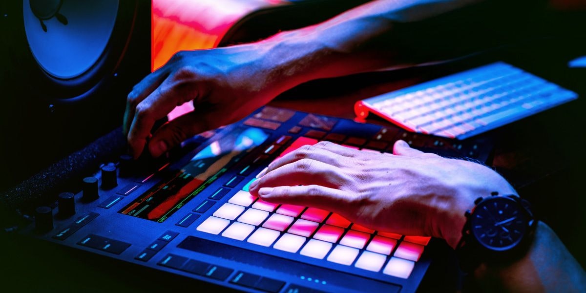 Hands using the controls of a MIDI controller