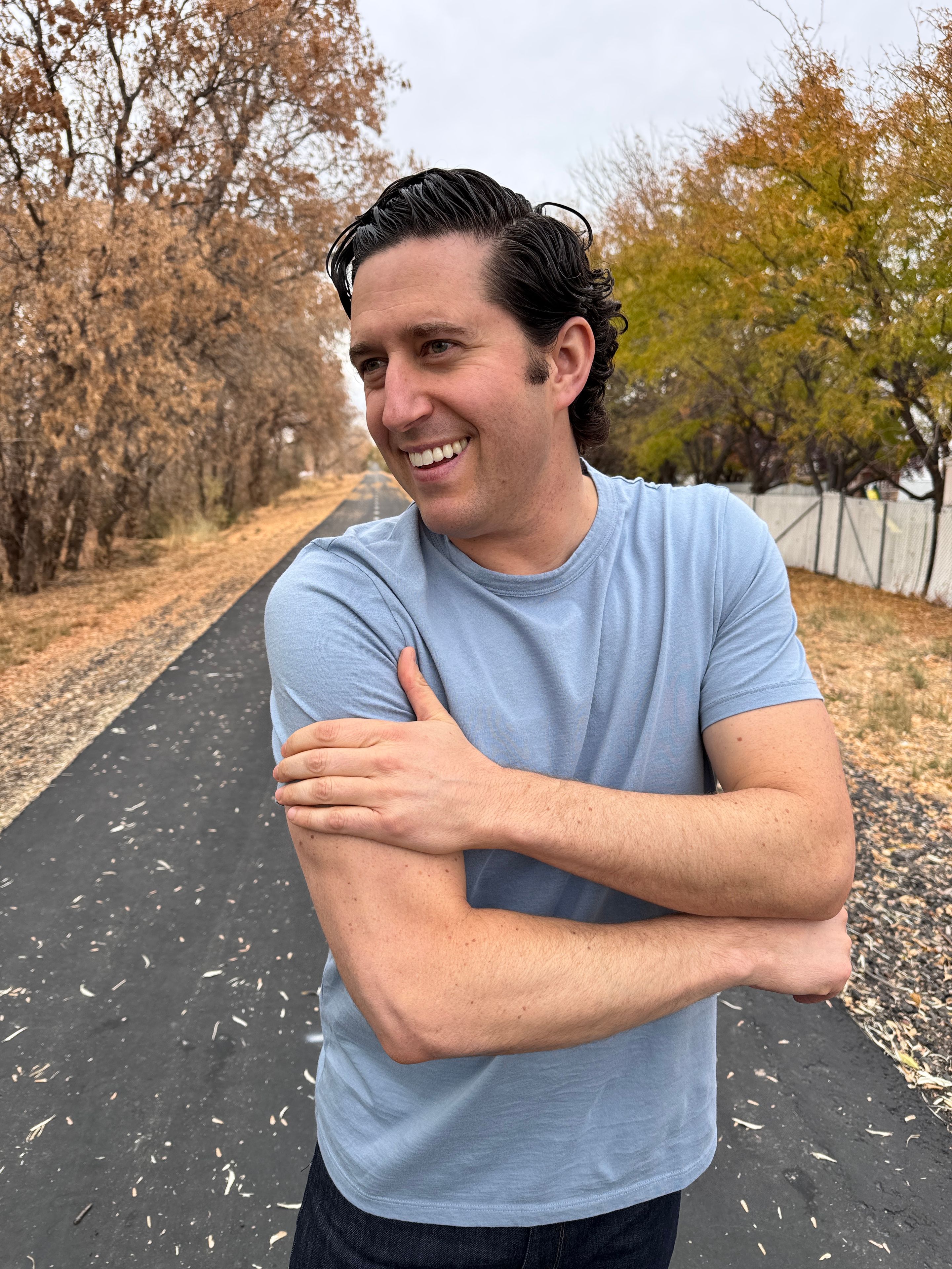 Man in a Sky Blue Heather Tech Tee on a running path