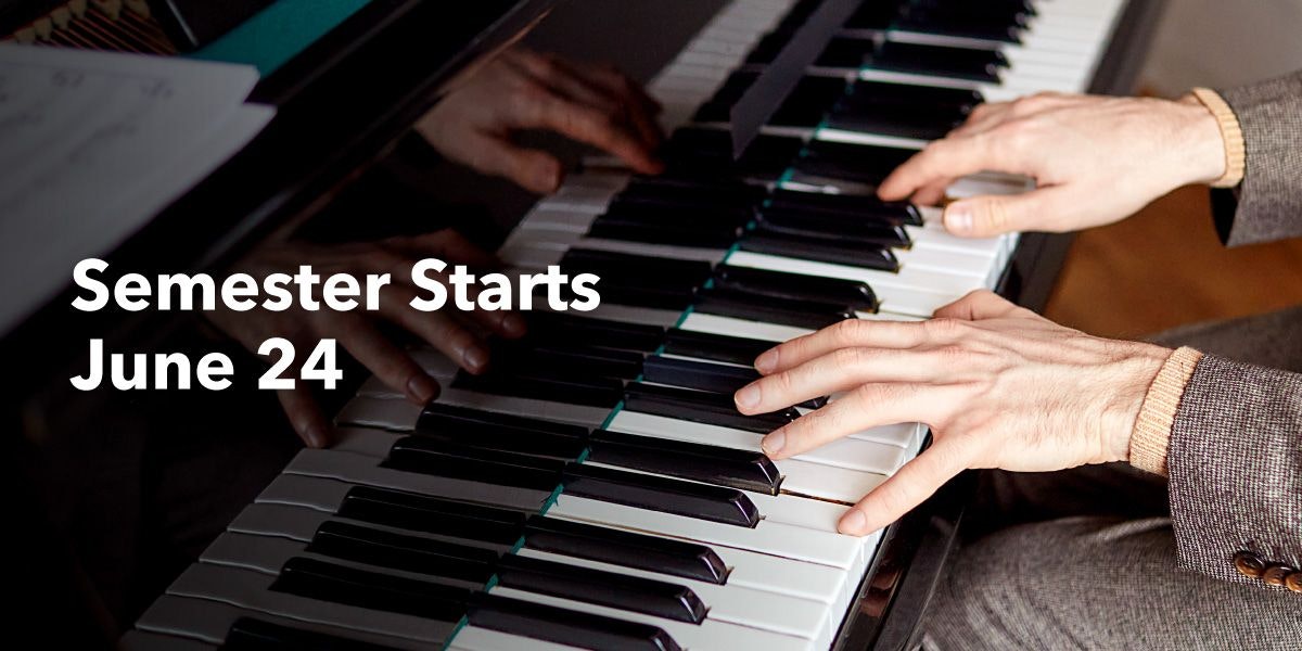 A person's hands playing a piano.