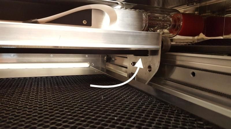 An image showing the belt pulley located on the underside of the Glowforge laser arm, on the right-hand side.
