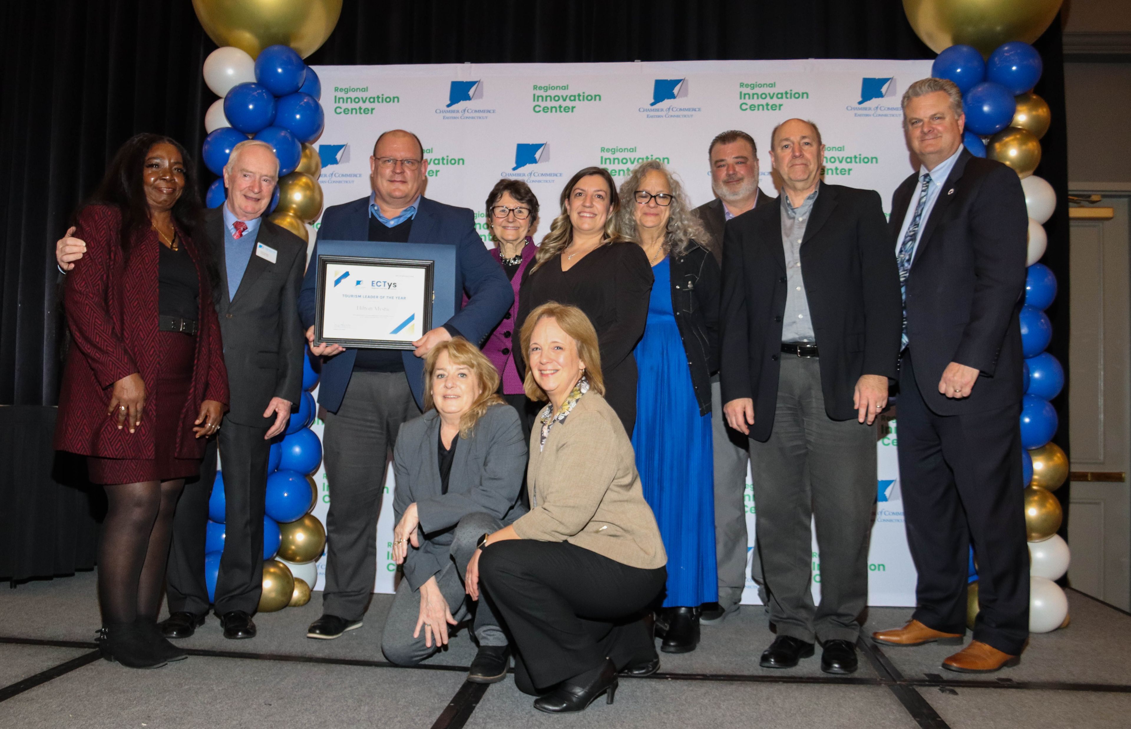 2024 ECT Chamber of Commerce, Awards Presentation. Hilton Mystic Tourism Leader of the Year.  Shown in Photo: Vivian McQuay, Housekeeping Manager; Tony Sheridan, President & CEO ECT Chamber of Commerce; Johan Liebenberg, General Manager; Tawny Gagne, Director of Food & Beverage; Michele Strobel, Catering & Events Manager; Joanna Tuneski, Sales Manager: Betty Eccles, Property Accountant; Jason Sior, Director of Facilities; Keith Lindelow, Director of Sales. ..... Photo by Anne Ogden