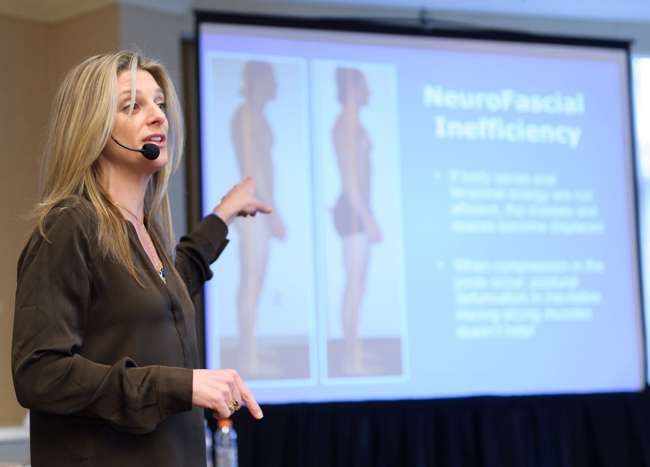 Presenter discussing neurofascial concepts at an IDEA Sessions event