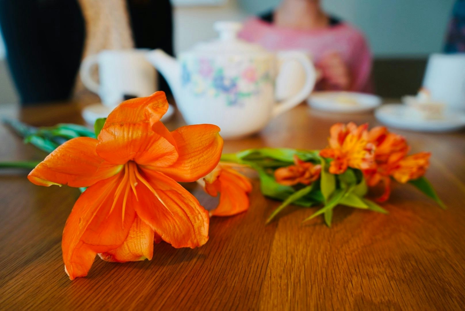 Flowers with tea kettle in background