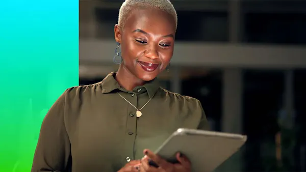 businesswoman reviewing documents on tablet