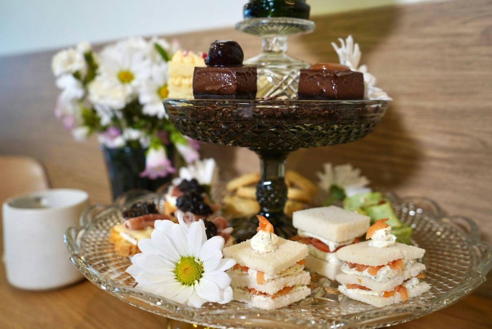 Assorted sandwiches and desserts on cake tray