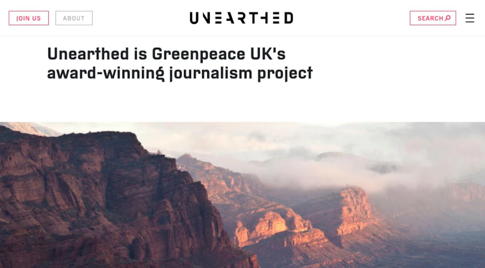 A website header with a scenic background of rugged mountains and mist