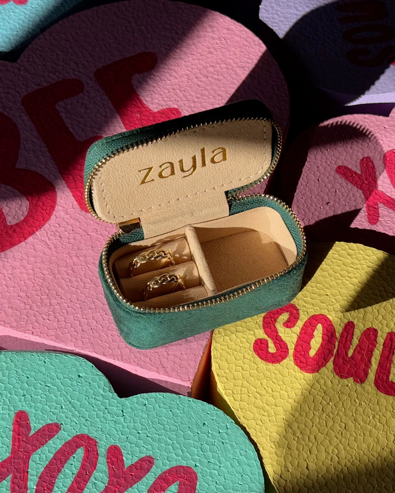 Zayla travel case with gold rings on candy hearts
