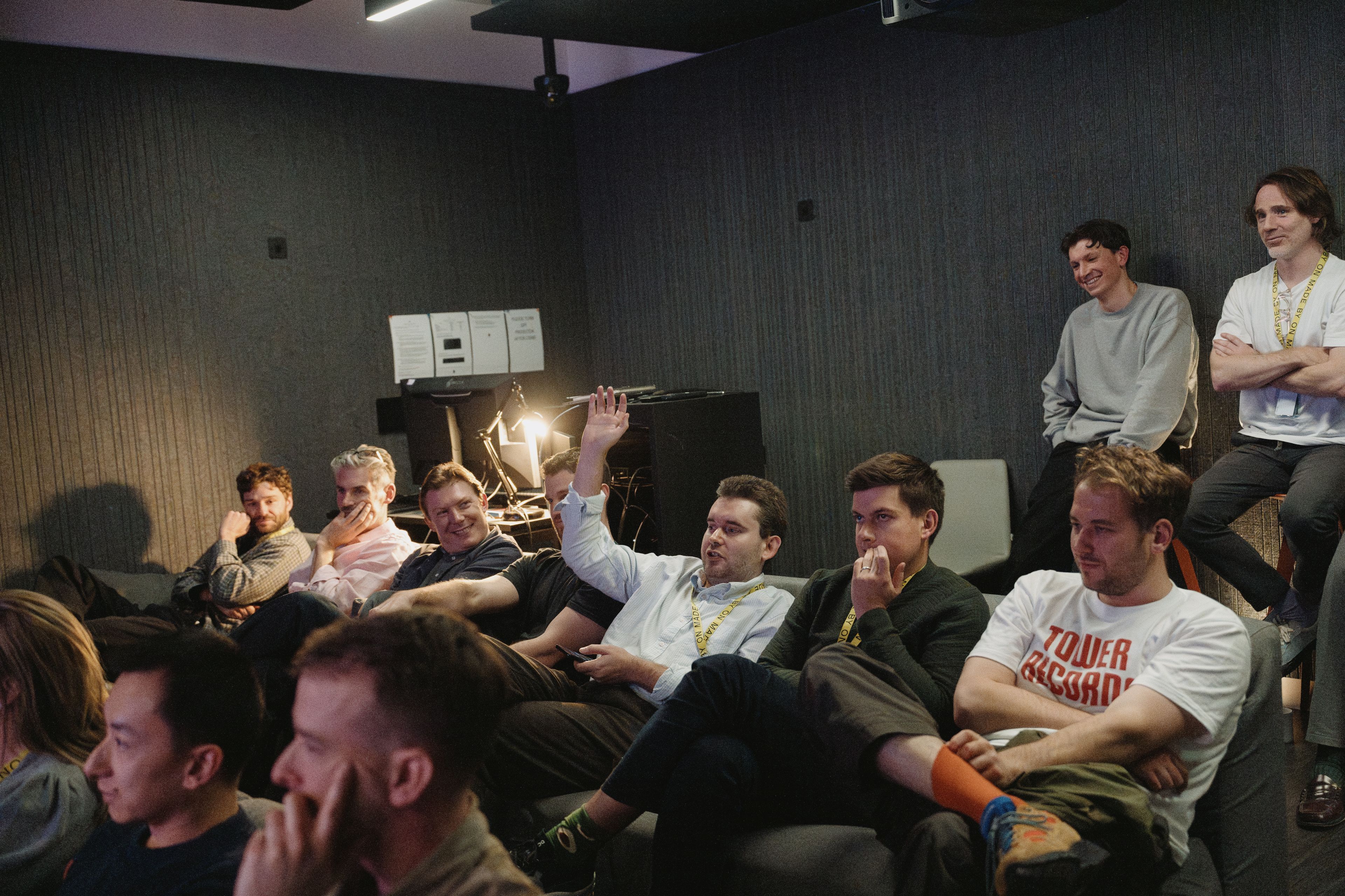 The team settled into the sofas of the studio’s cinema room, one hand up with a question