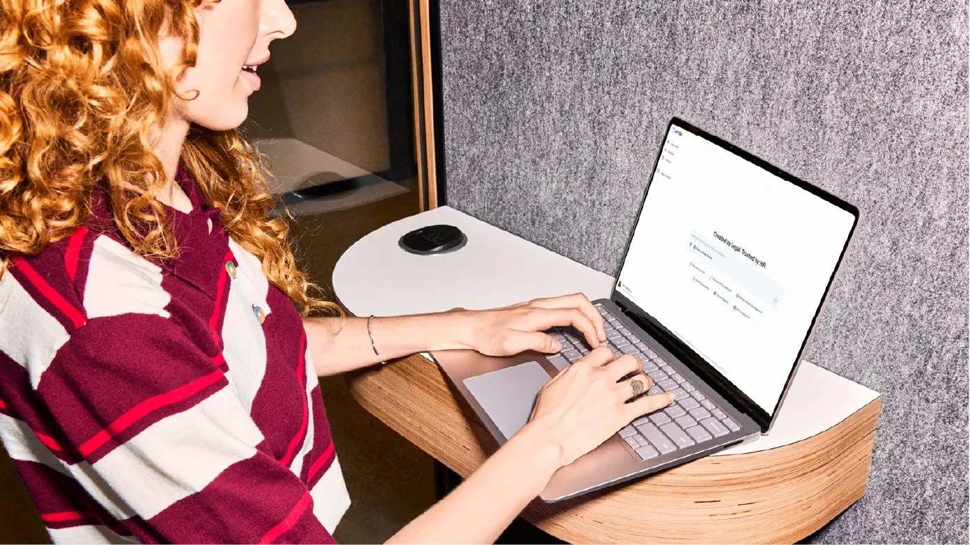 A human resources professional uses G-P Gia AI-powered platform on her laptop to efficiently manage global HR compliance requirements.