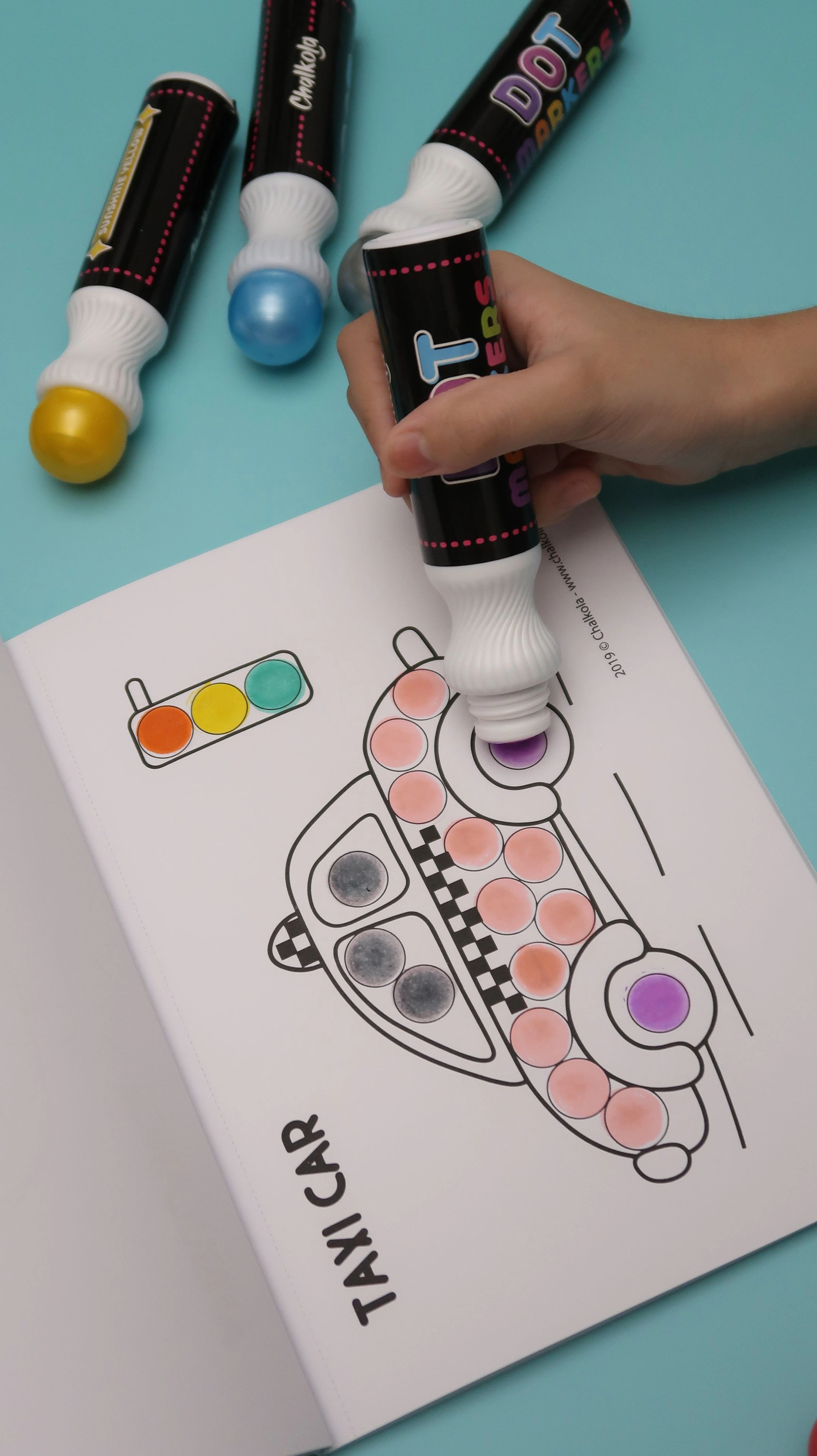 Kids' hands with washable dot marker ink — easy to clean