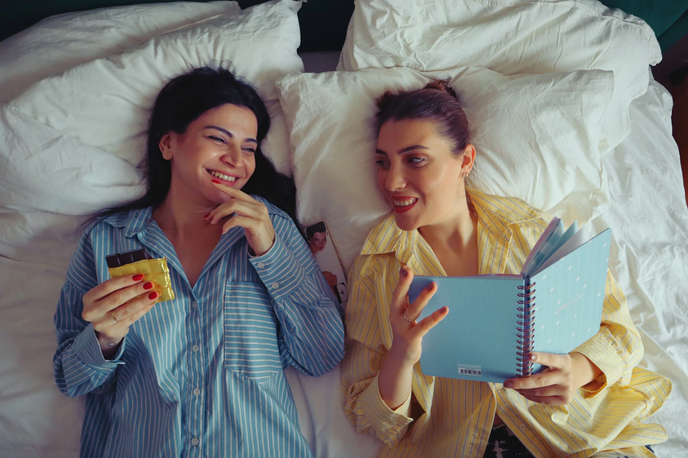 Best friends laughing together in pajamas