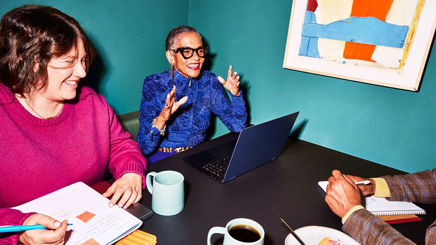 two business professionals discussing project at a conference table