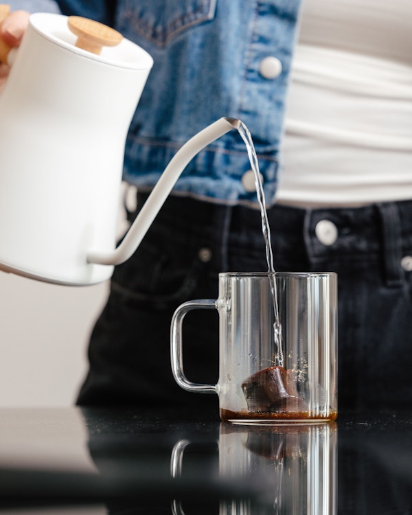 Pouring hot water over the frozen coffee puck