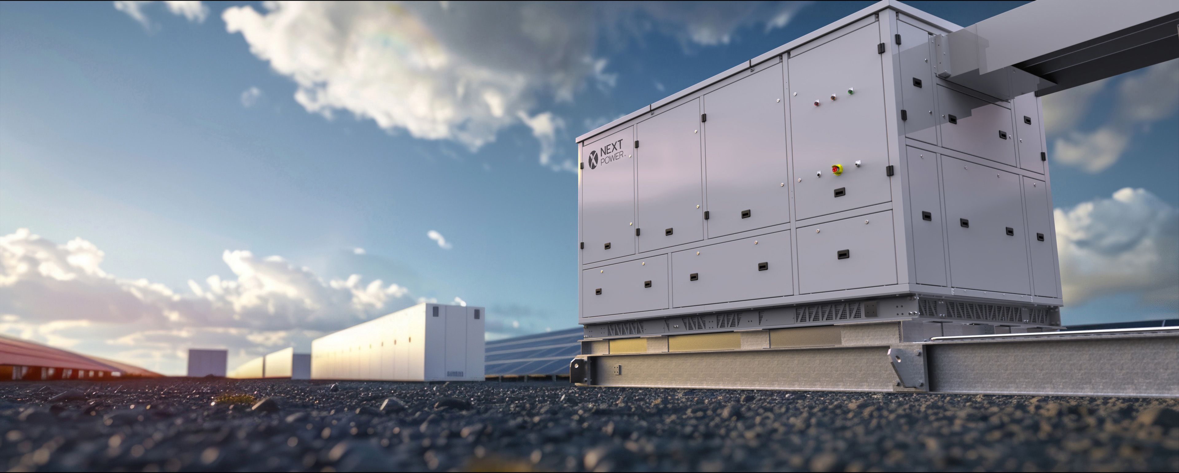 Image shows a Nextpower inverter from a low angle against a cloudy blue sky. 