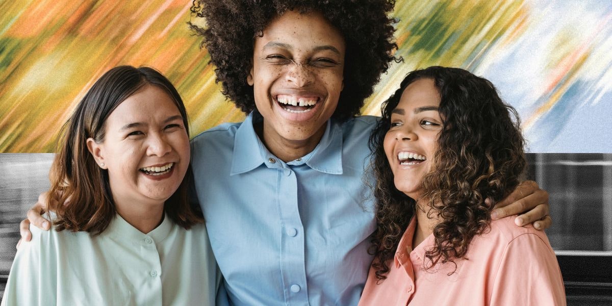 Friends smiling and hugging eachother