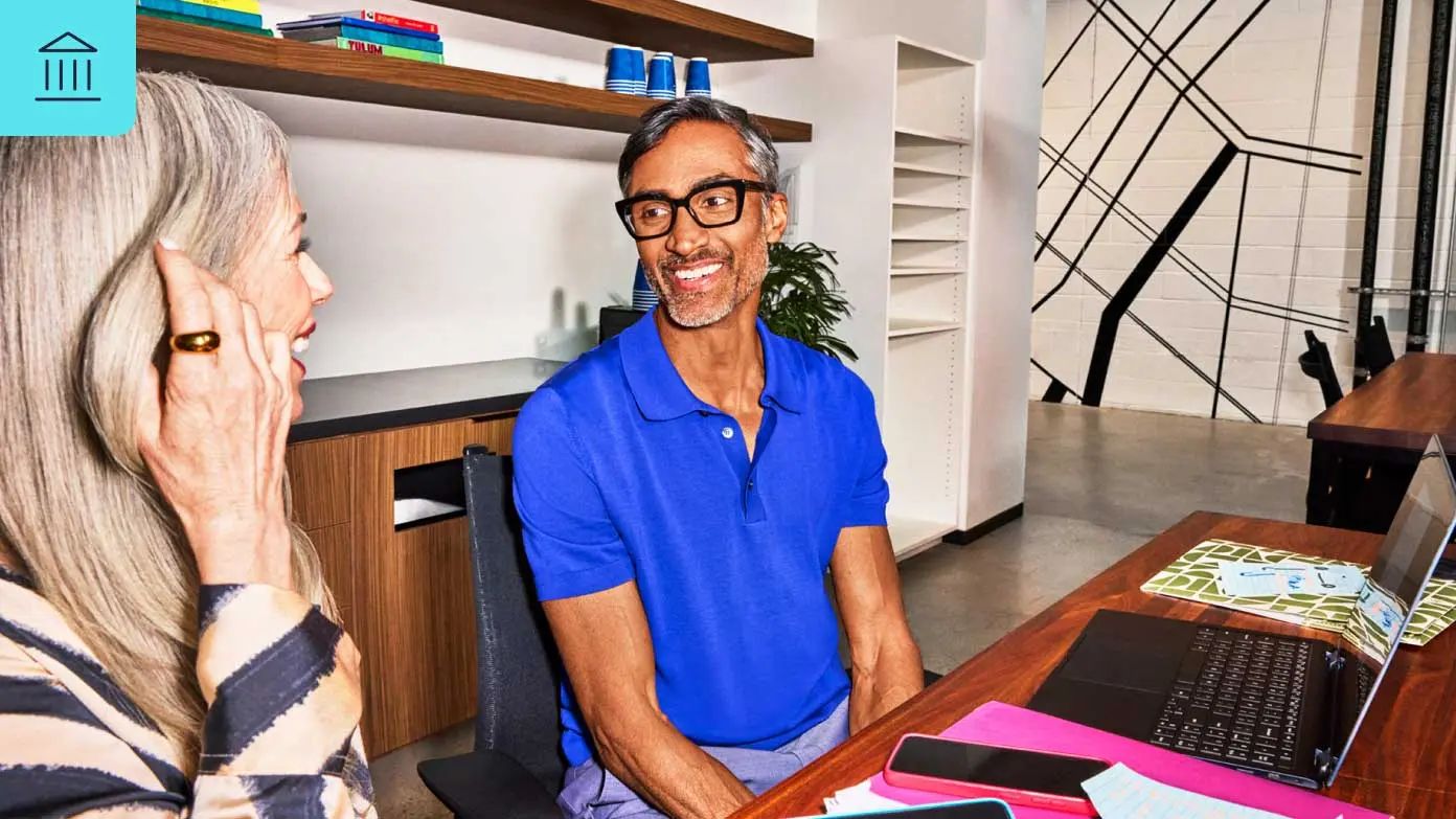  a man and a woman are engaged in a conversation in an office
