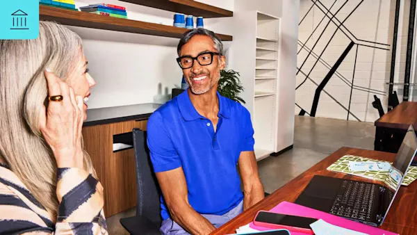 a man and a woman are engaged in a conversation in an office