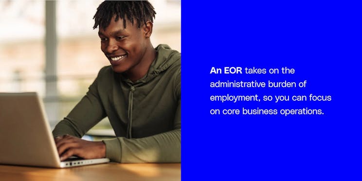 A professional focused on core business operations at their laptop, demonstrating how an Employer of Record (EOR) removes the administrative burden of employment.