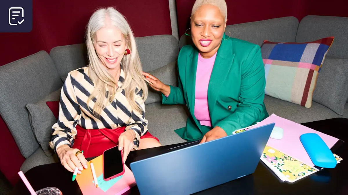 Co-workers viewing laptop