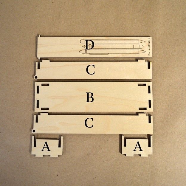 Laser cut parts for a wooden pencil case, labeled A through D
