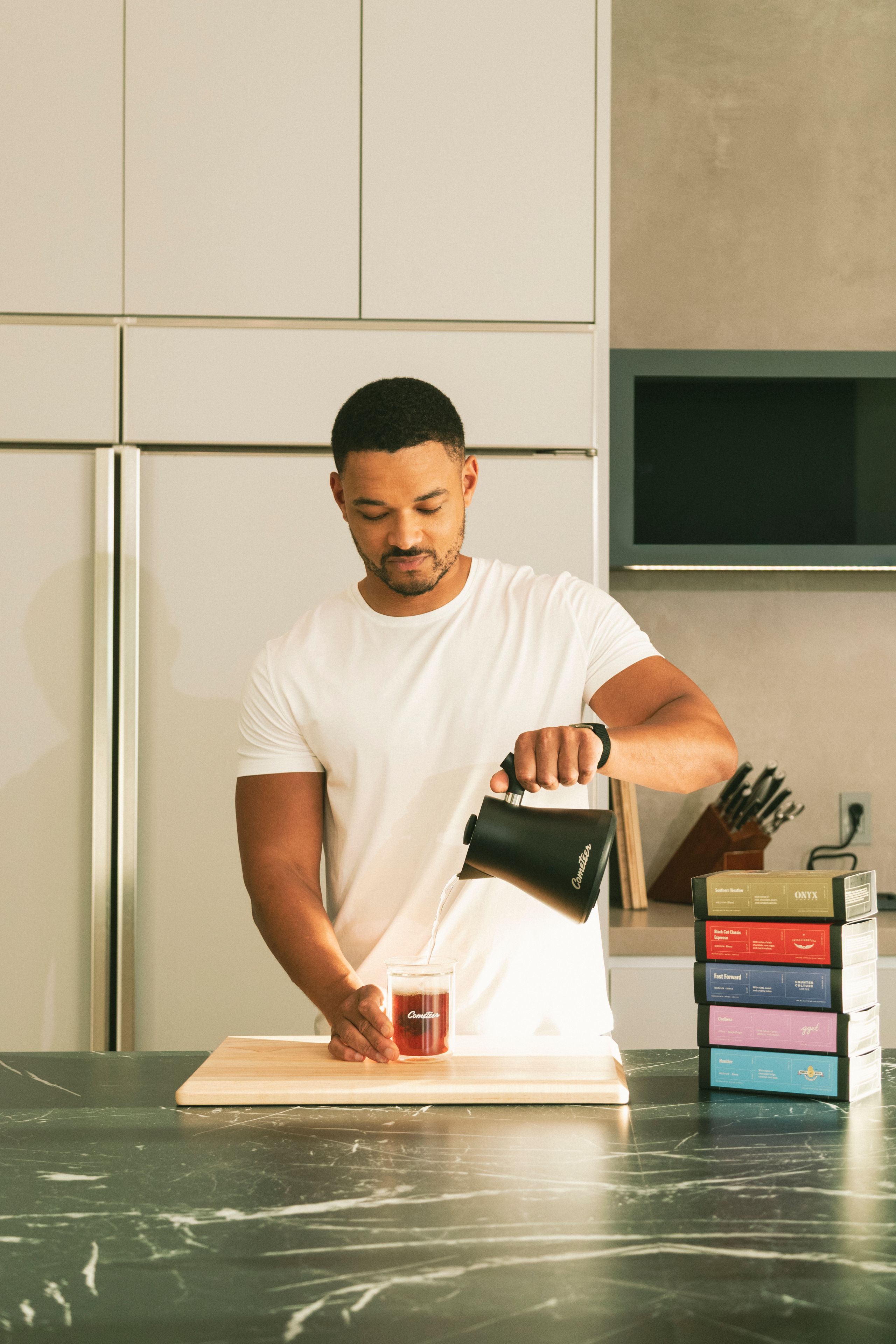 Steven Bartlett pouring hot water from a kettle over the coffee puck