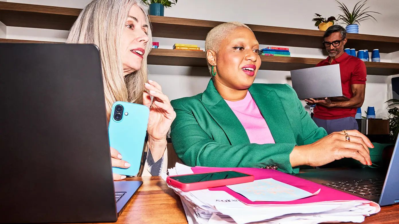 This image shows a group of people engaged in a collaborative work session in an office setting. 