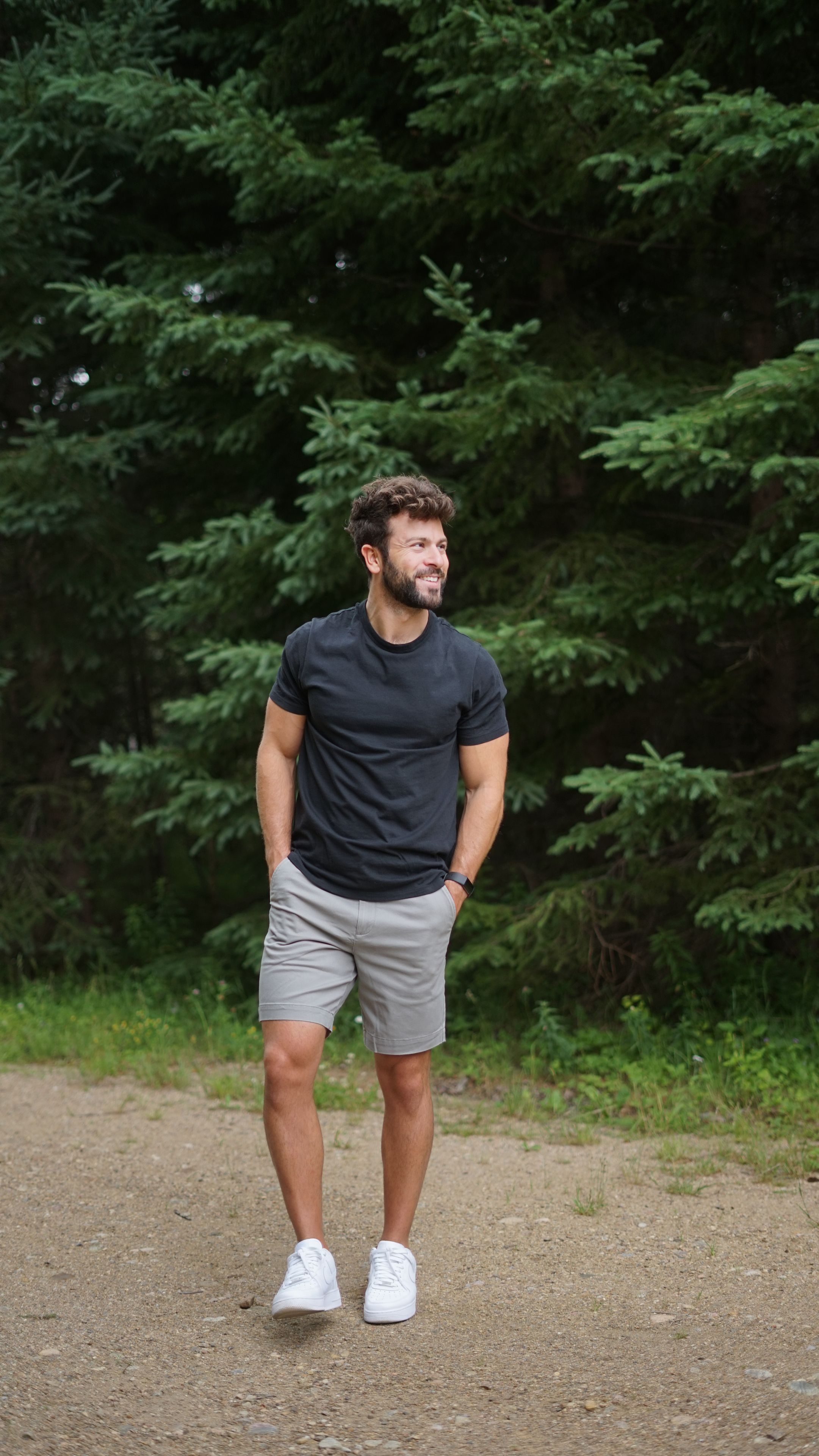 Man in a black Tech Tee and gray shorts outdoors