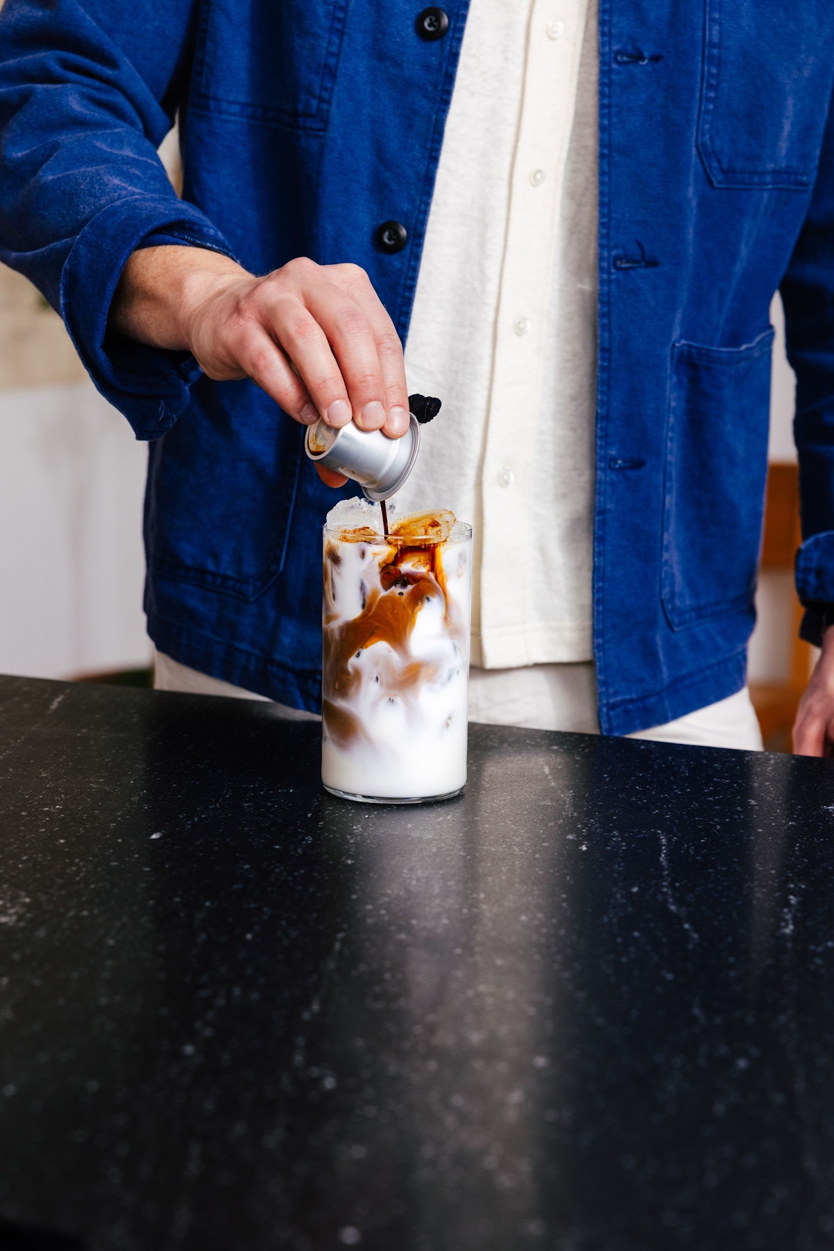 Cometeer capsule being poured into iced coffee