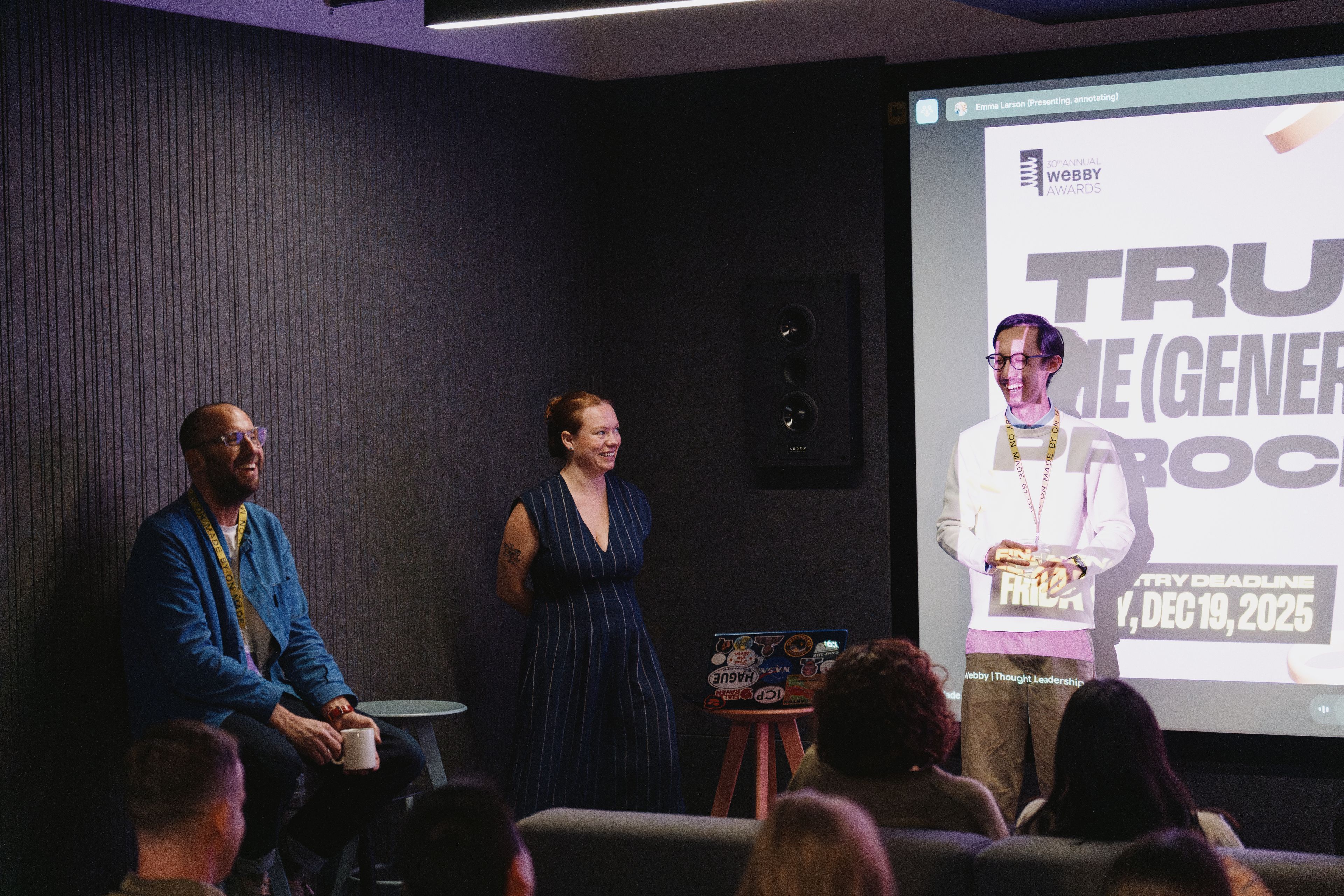 A presentation at the company meeting: two of the team at the screen, the room watching