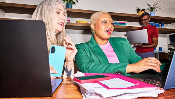 business professionals working on laptops in an office
