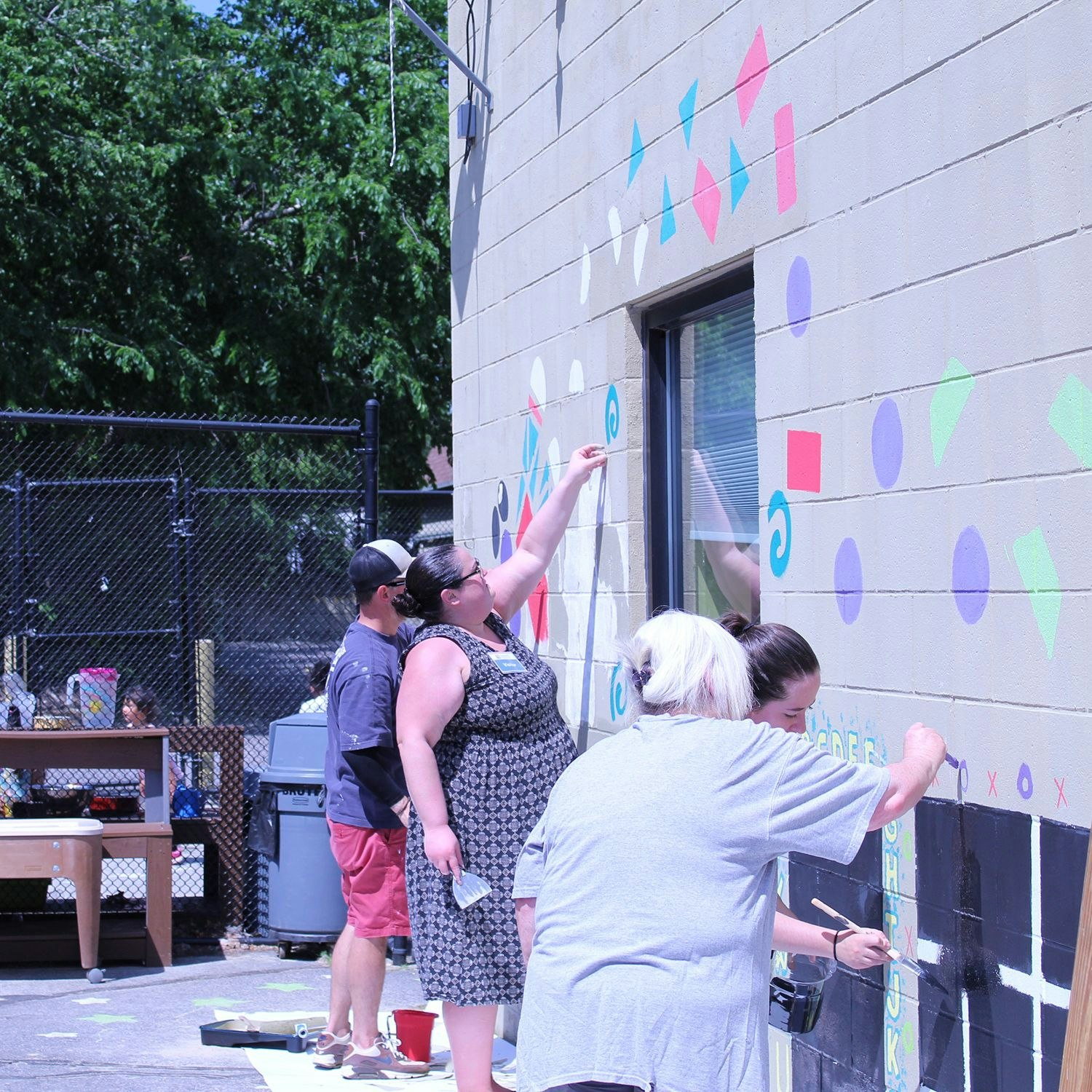 Volunteers painting a mural.