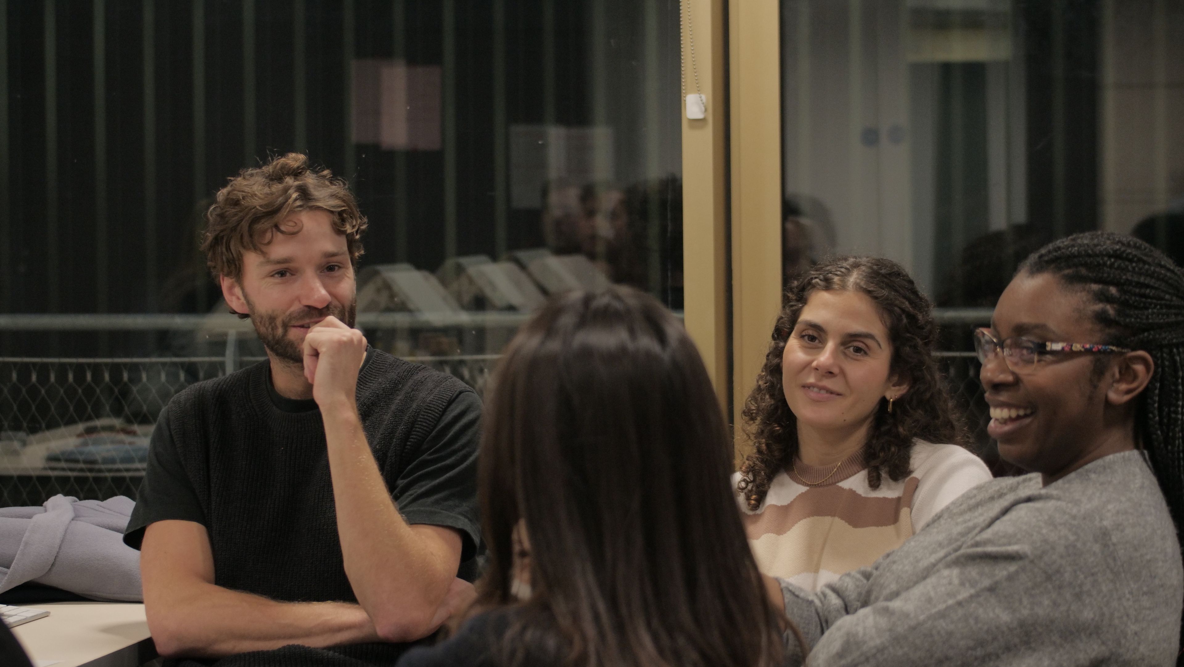 The team having a discussion, one of them laughing