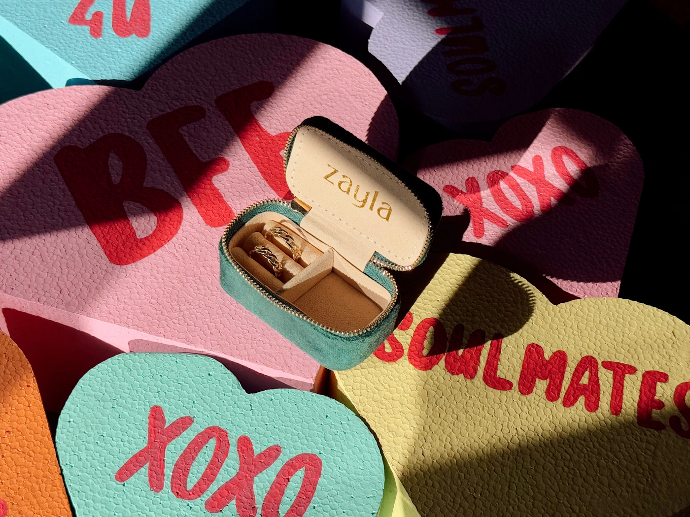 Zayla ring box with matching gold rings on BFF and XOXO candy hearts