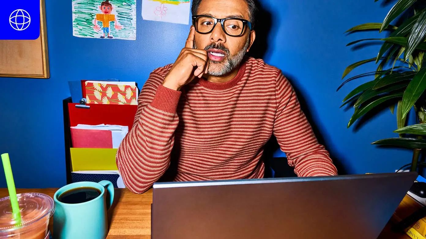 a person sitting at a desk in a home office setting